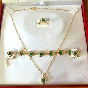 Jewelry set contains pair of earrings, ring, bracelet and necklace.